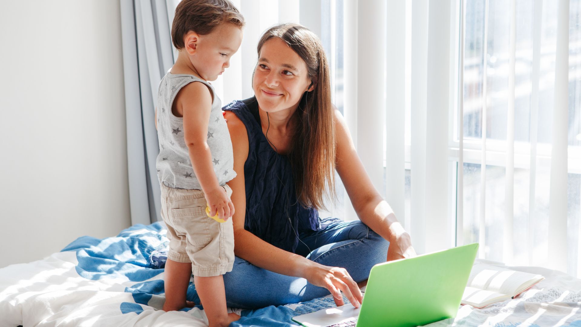 mom and toddler as mom works on computer